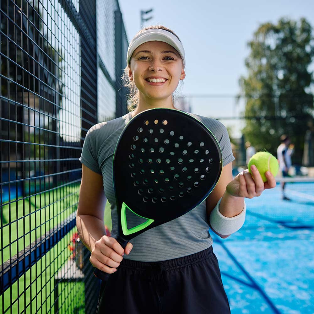 young-athletic-woman-playing-paddle-tennis-on-outd-WUP7D6S.jpg